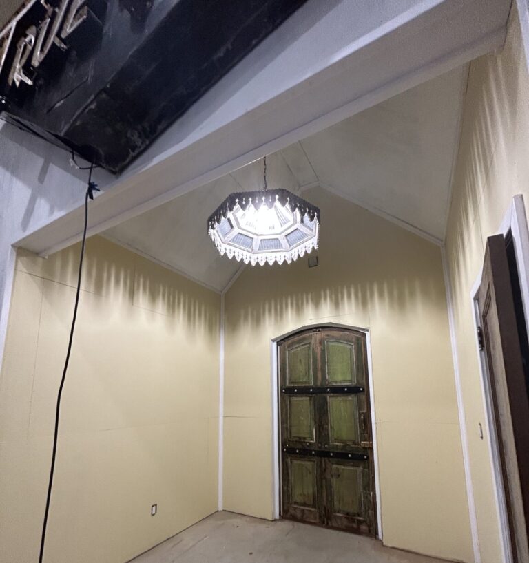 yellow room with big chandelier