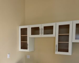 light green cabinets on a yellow wall